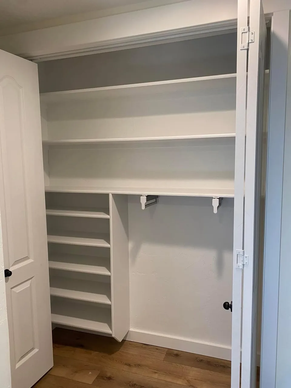 Custom white closet shelves and hanging storage