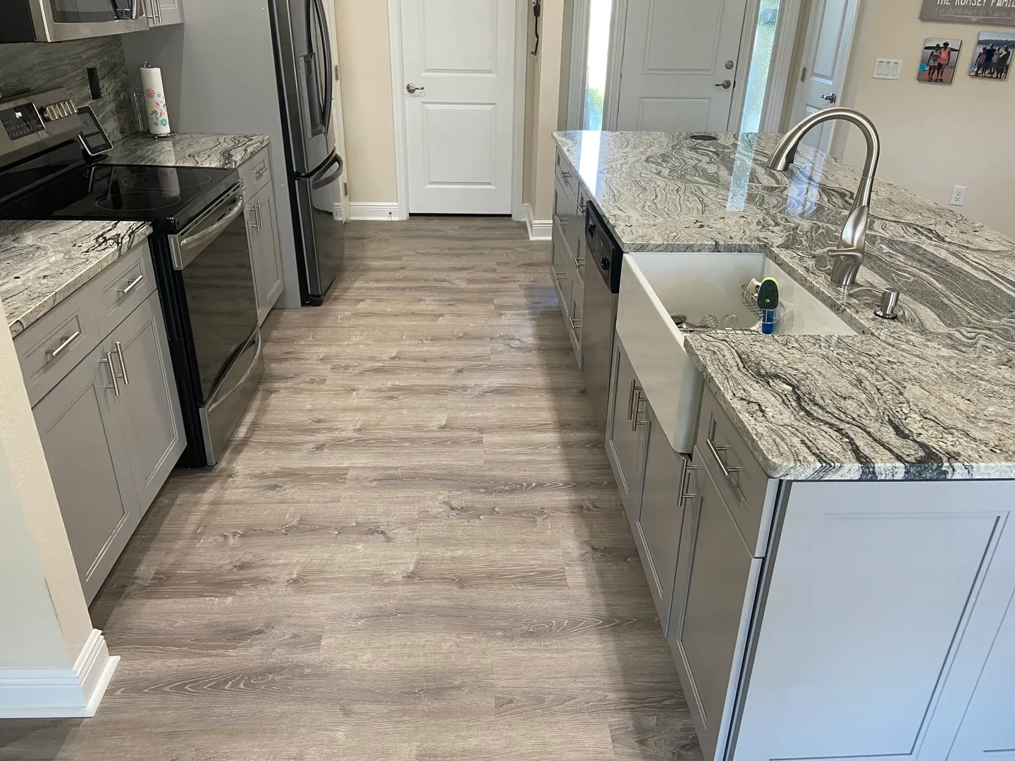 Wood-look flooring installed throughout a completed kitchen